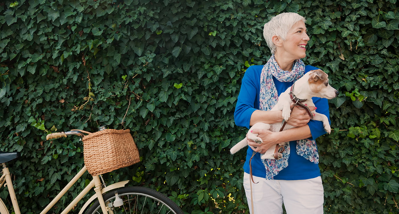 A lady holding her dog